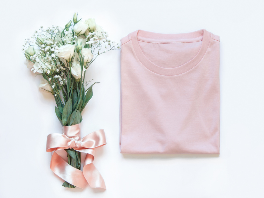 Folded T-Shirt Placed near White Flowers